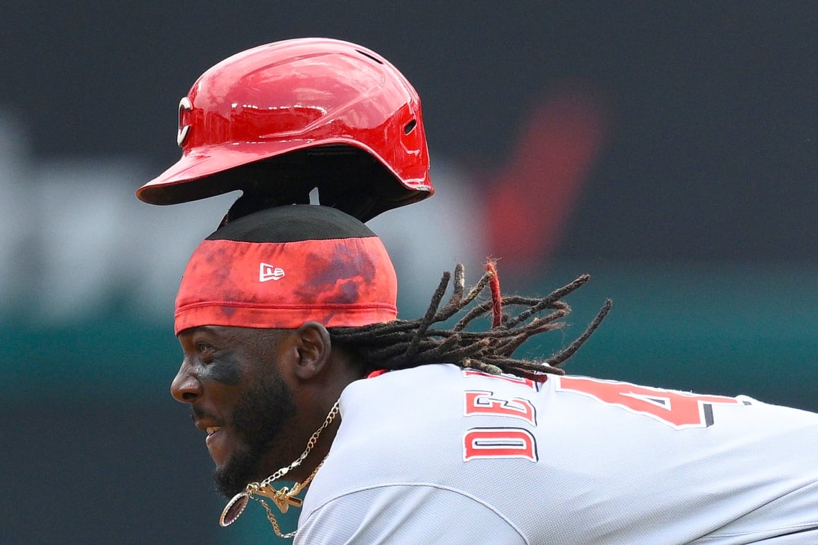 A mans red helmet floats above his head as he dives.