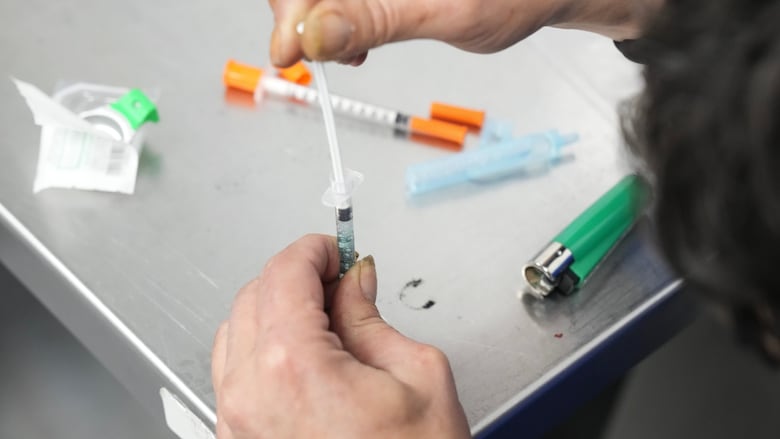 A person prepares injectable drugs.