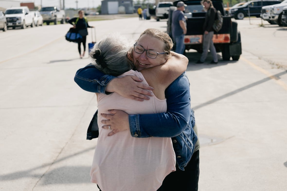 Two women hugging.