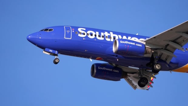 A passenger plane is seen flying in the air.