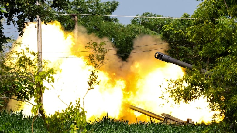 Howitzers fire rounds.