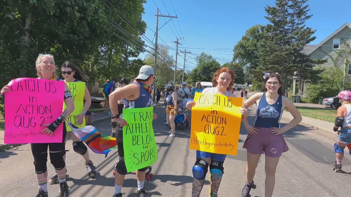 Four people are holding signs on bright posters.