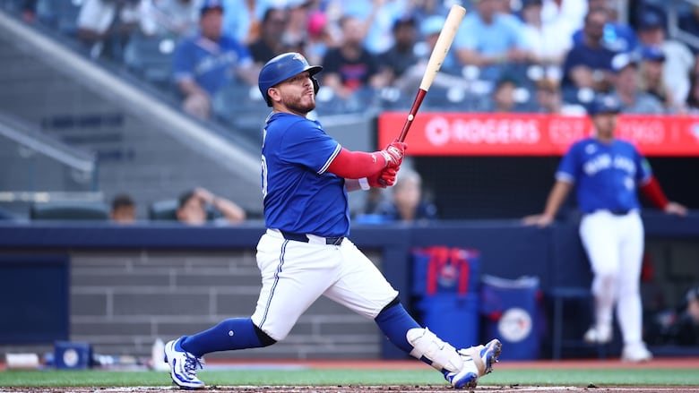 A men's baseball player hits a double.