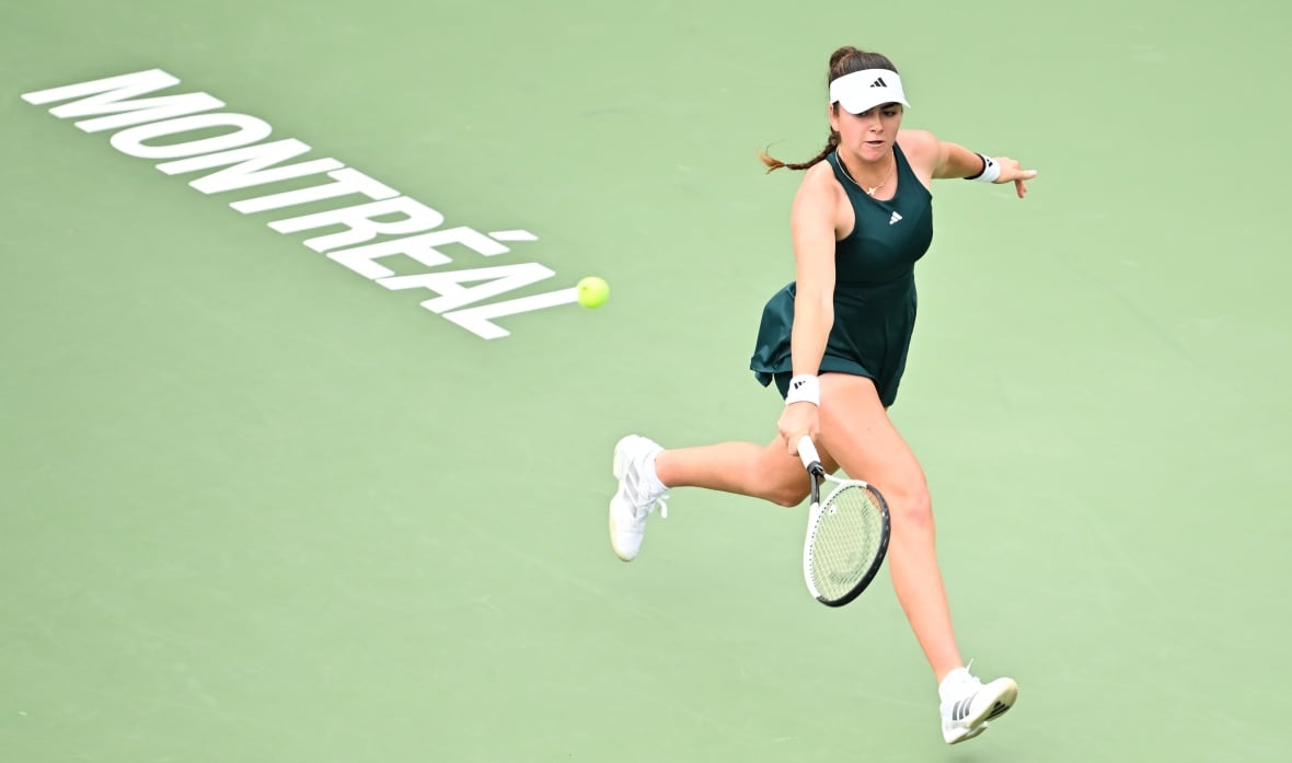 A women's tennis player runs to play a backhand shot.