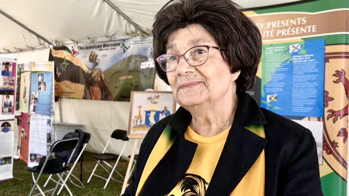 A woman with glasses with the jamaican colors. 