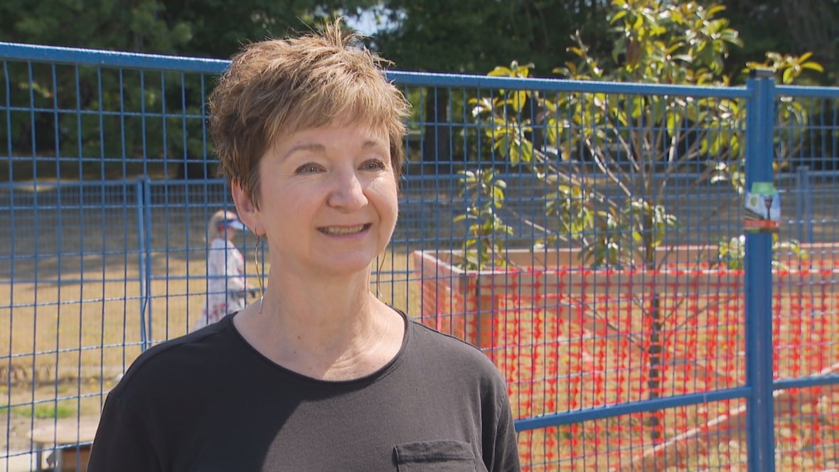 A woman dressed in black smiles for the camera.