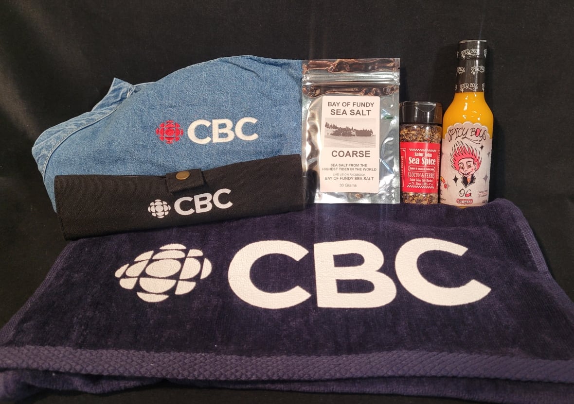 A photo of items to be included in a prize package, including sea' spice, a CBC Apron, Hot sauce, sea salt and CBC Cutlery.