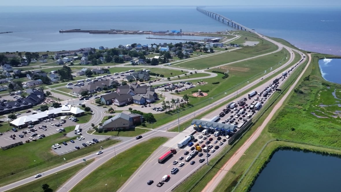 Lines of cars wait to pay at toll booths at the Confederation Bridge