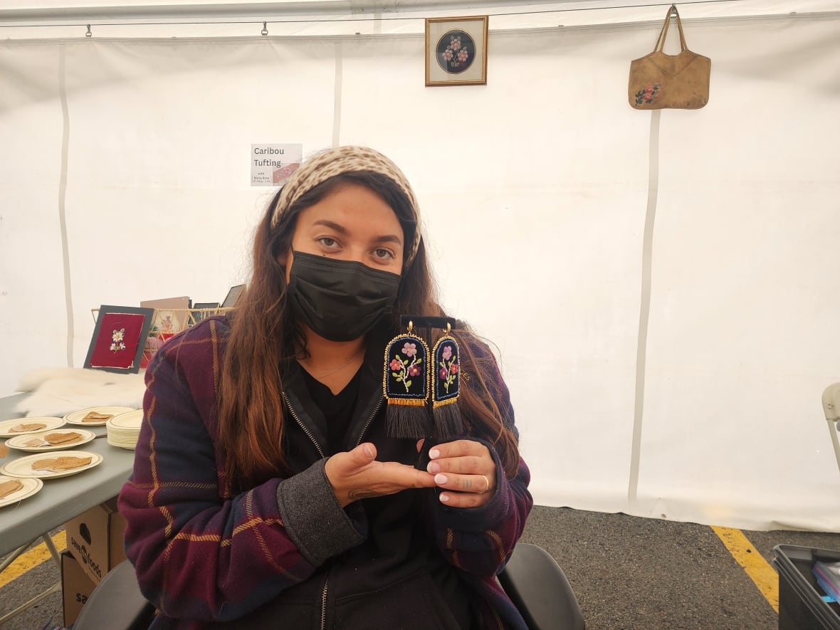 Dene artist Maria Rose Sikyea poses with her caribou tuft.