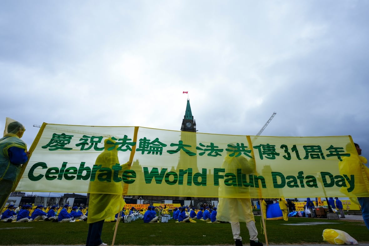 A banner says 'celebrate world falun dafa day.'