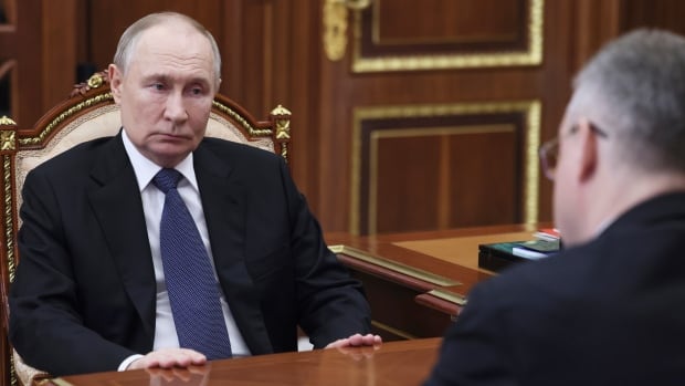 Russian President Vladimir Putin speaks with Vladimir Vladimirov at the Kremlin.
