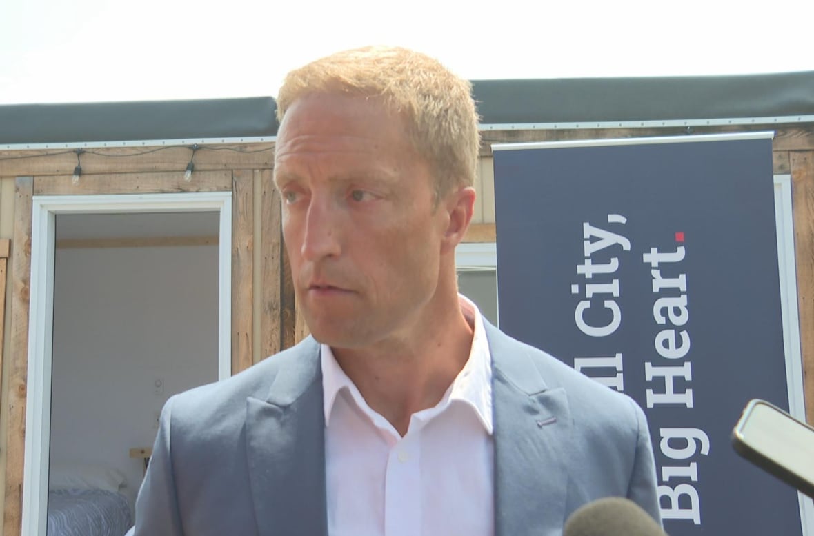 Man looking off side of camera with a neutral expression
