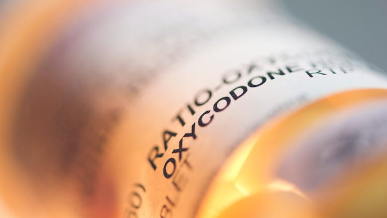 A prescription bottle with an oxycodone label. 