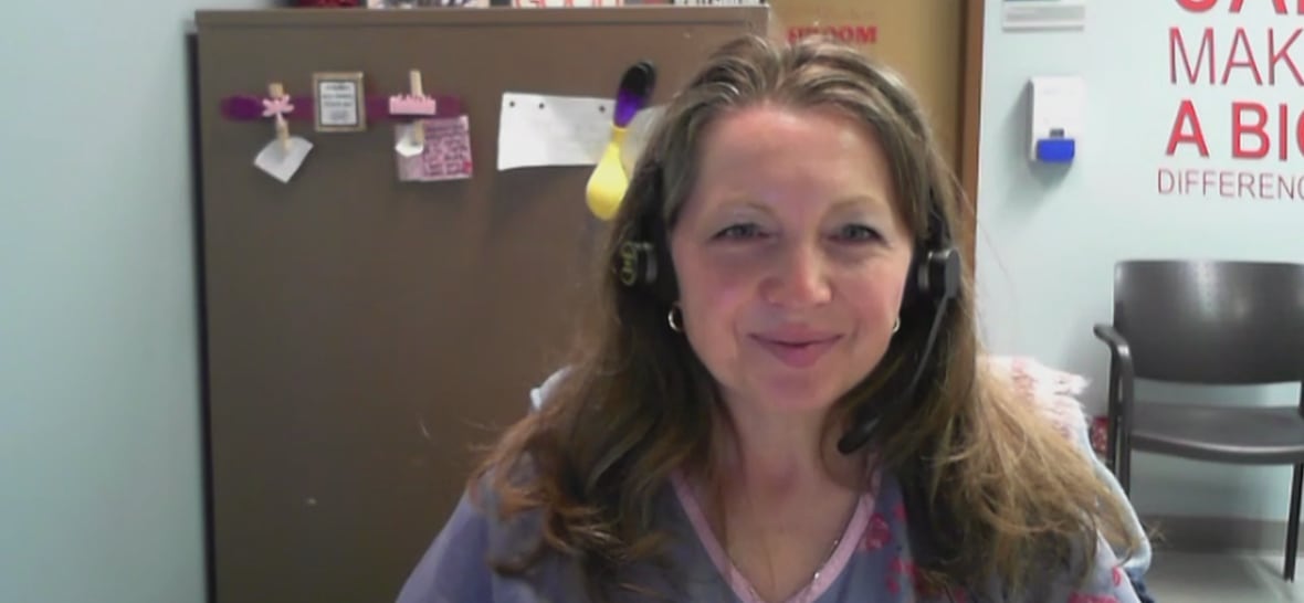 A woman with brown hair in an office.