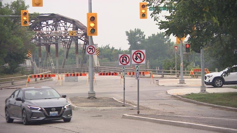 Barricades and closure signs can be seen erected at a bridge.
