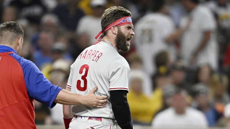 A men's baseball player yells during a game.