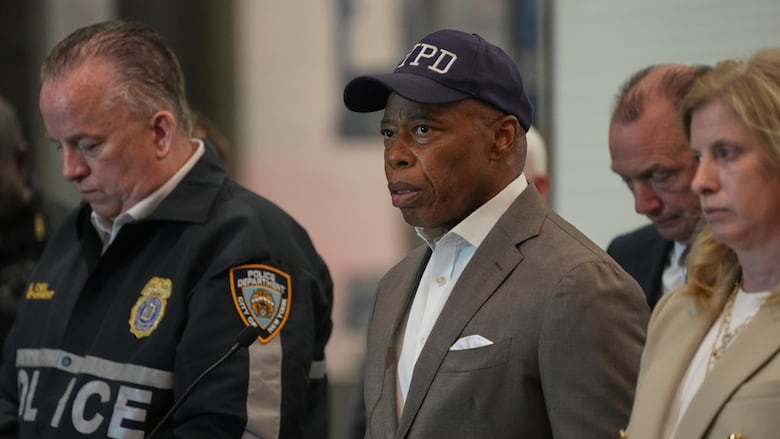 New York Mayor Eric Adams, center, speaks during a news conference.