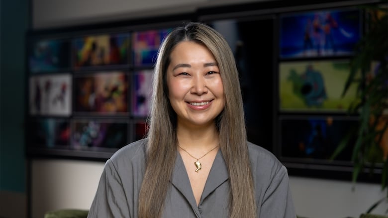 Photo of a woman standing in front of storyboards for an animated film