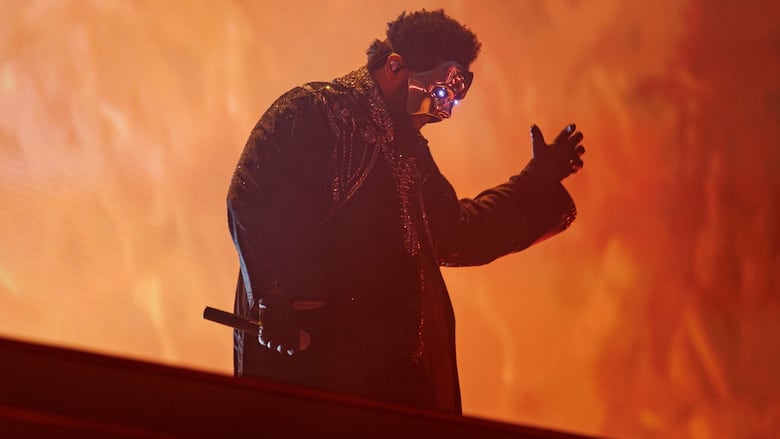 A man in a mask on stage performing.