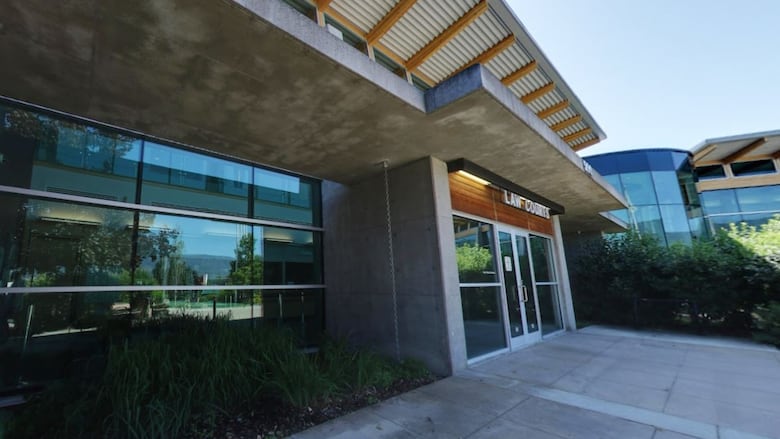 A glass and concrete building with a sign reading, 'Law Courts.'