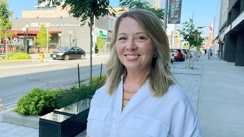 Portrait of woman smiling at camera in downtown street in Kitchener