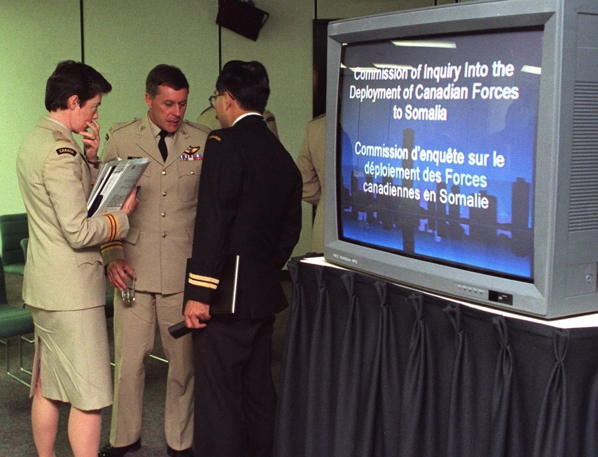 National Defense personnel members confer during a break in the Commission for the Research on the deployment of Canadian forces to Somalia, on October 2, 1995. (CP Photo/Fred Chartrand)