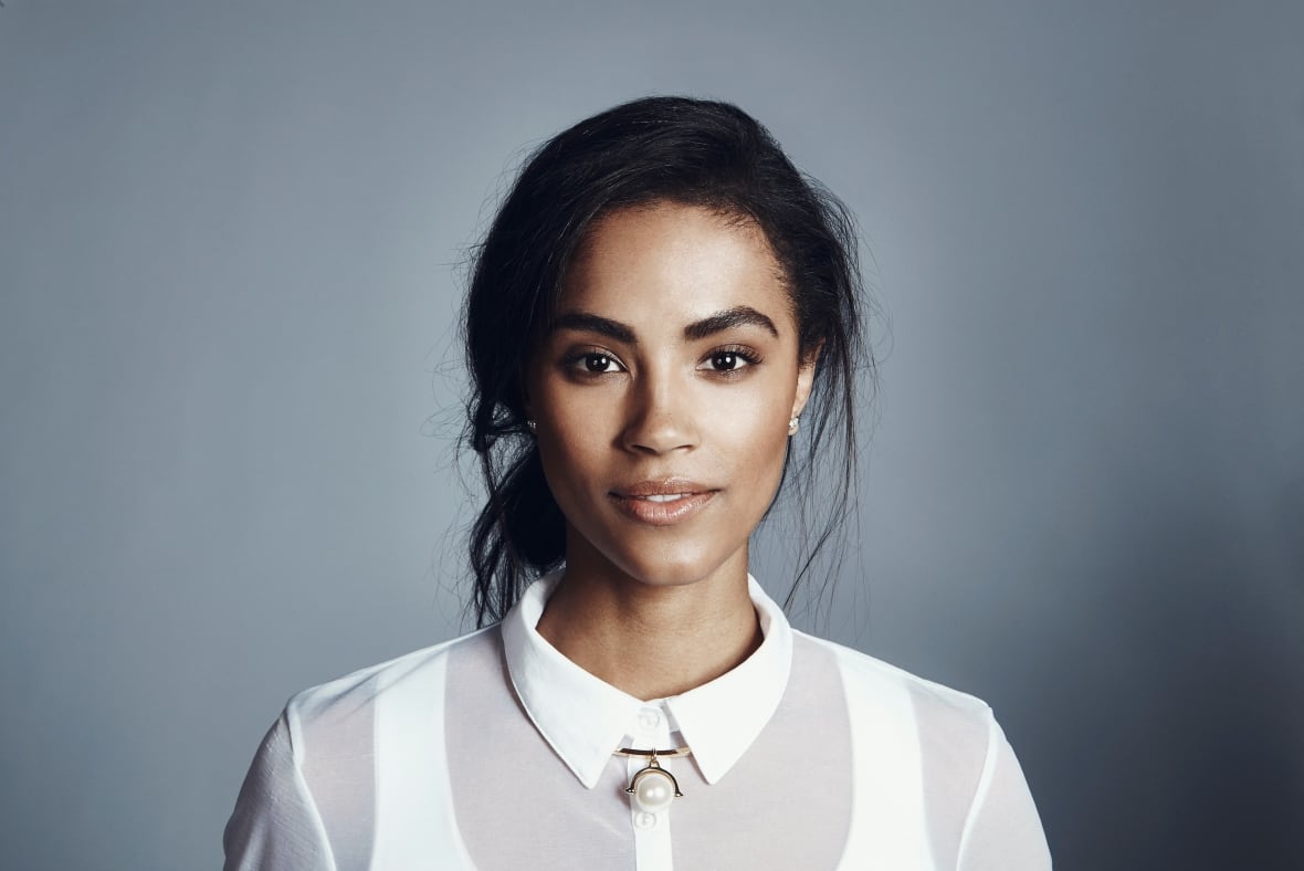 A professional photo shot in a woman's head with a white shirt in front of the camera.