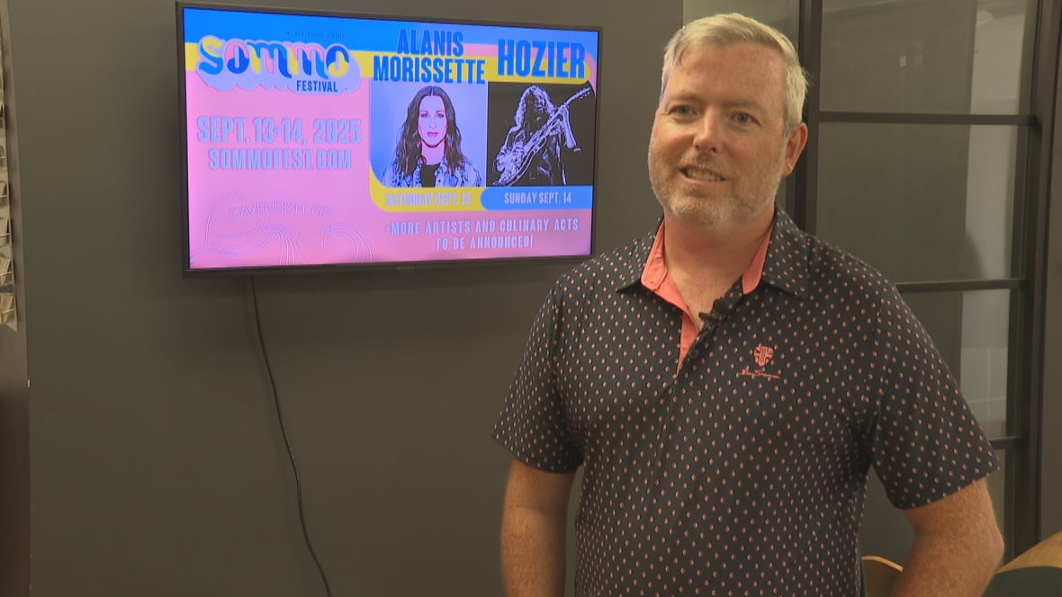 A man in a black shirt with pink dots.
