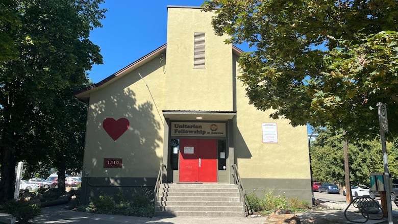 A yellow church is pictured.