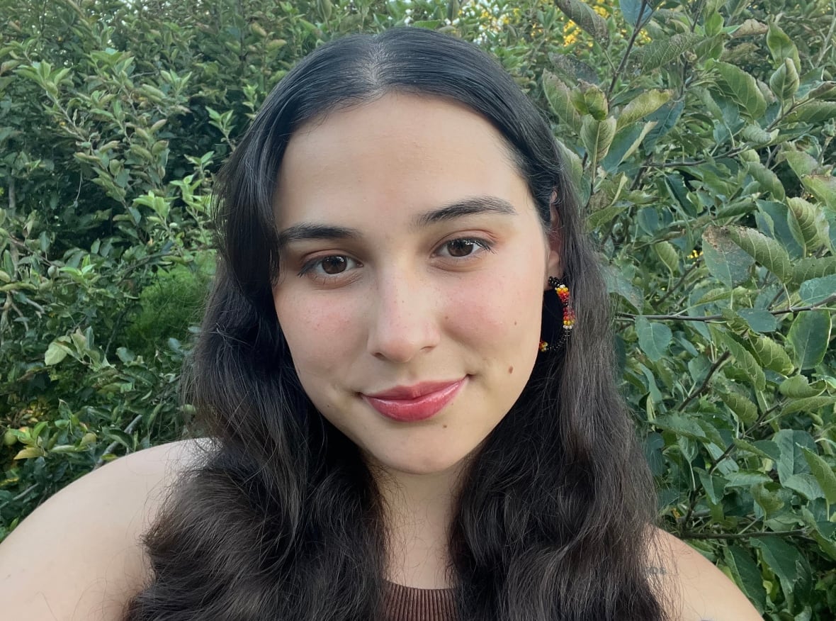 Selfie of the artist against a forest backdrop.