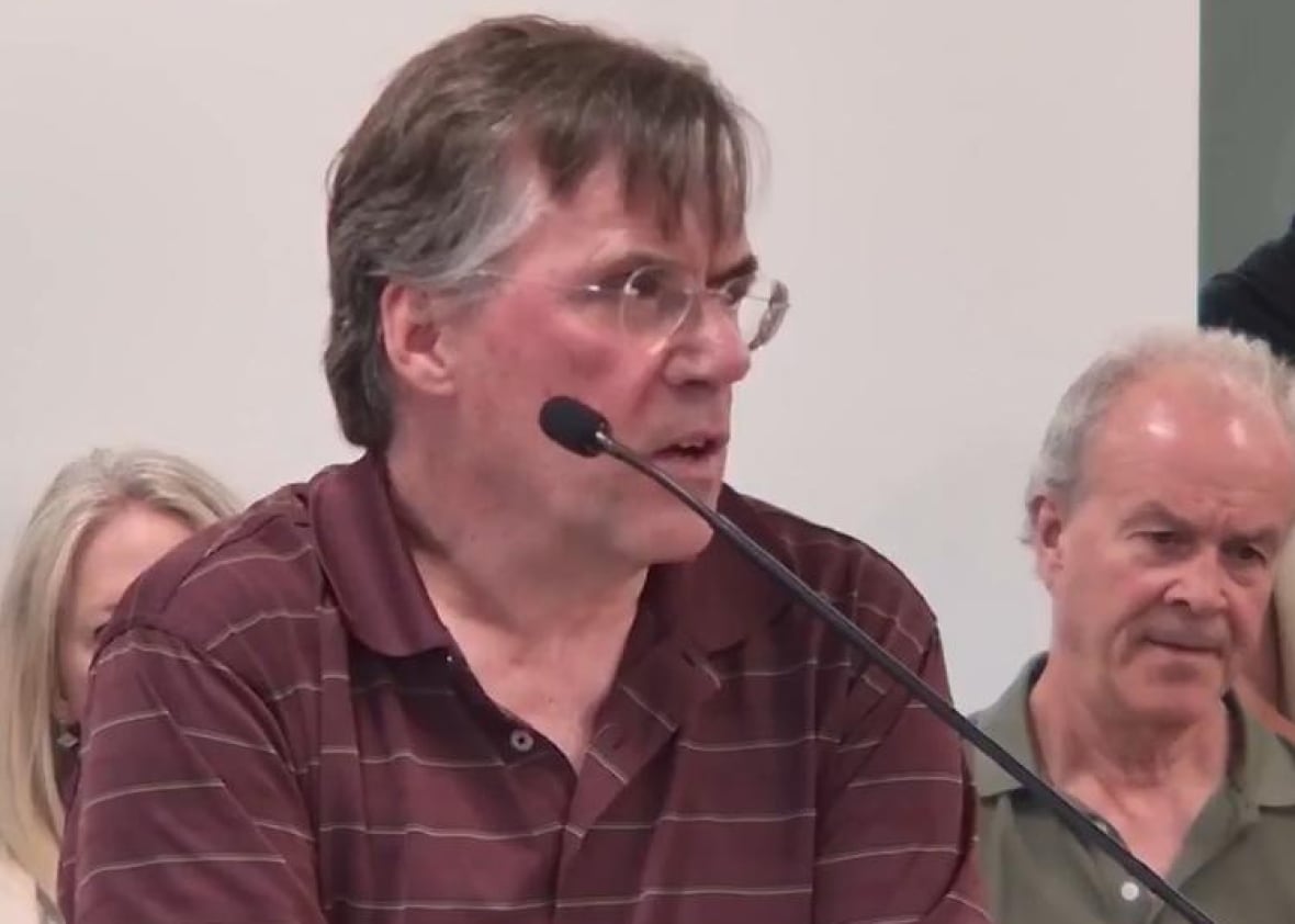 A man in a red collared shirt.