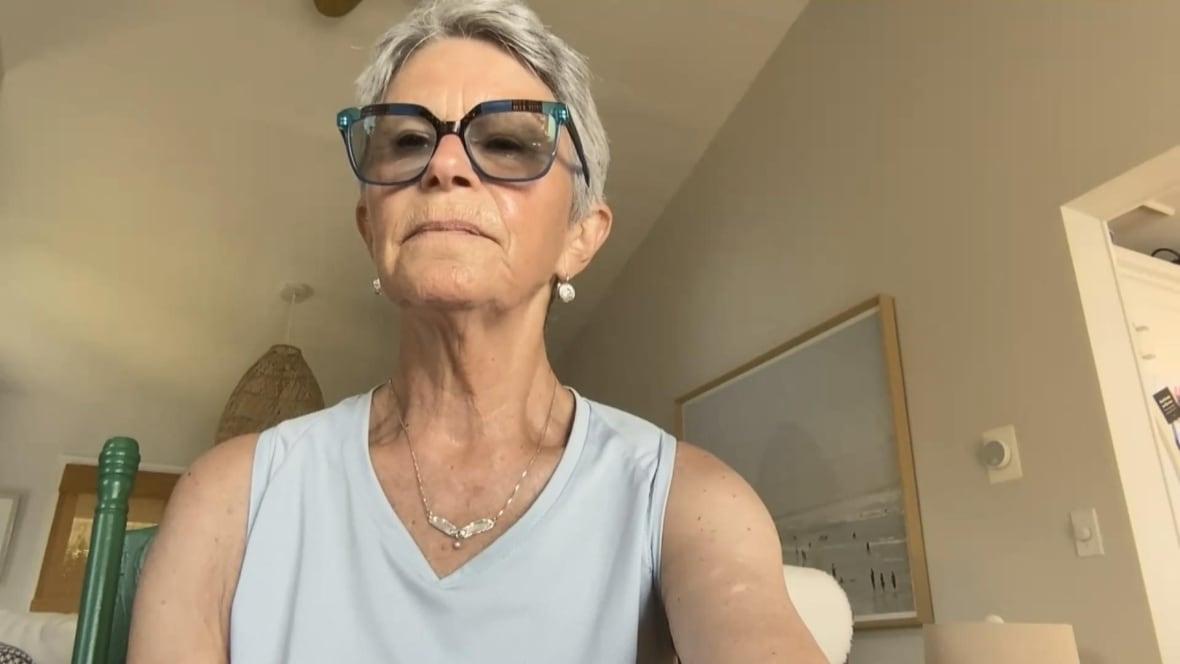A woman with glasses and short, grey hair. 
