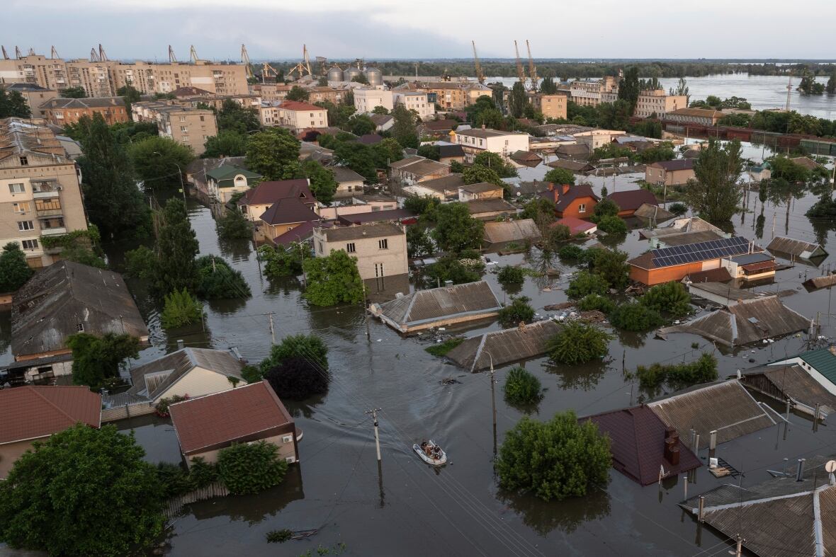 An aerial view of a town is shown with water levels rising. 