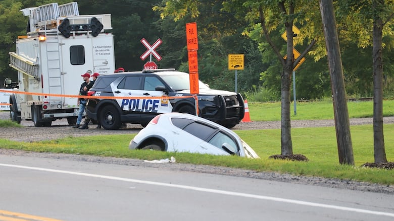 A police car parked at the scene of an accident