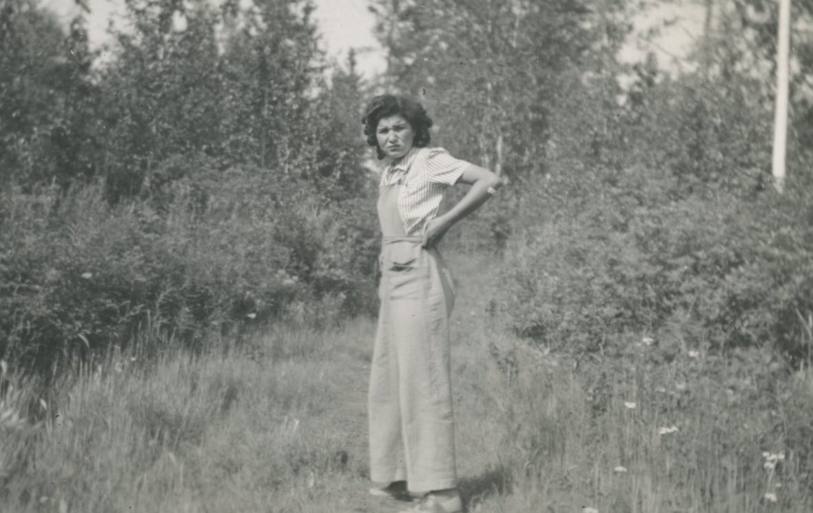 A young woman stands in the forest
