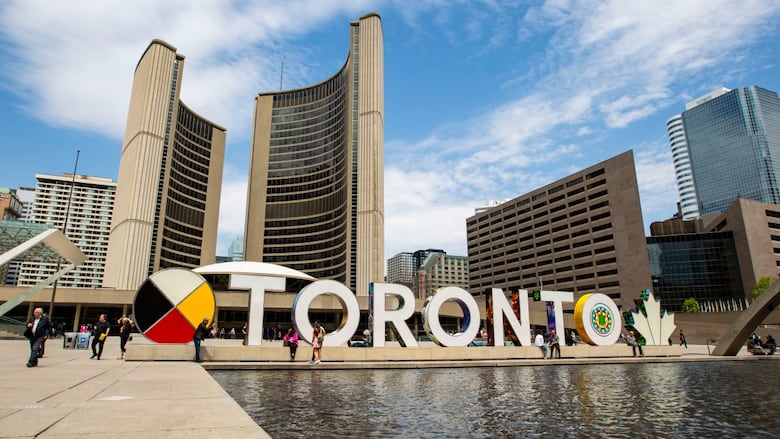 The Toronto sign in the daytime in front of City Hall 