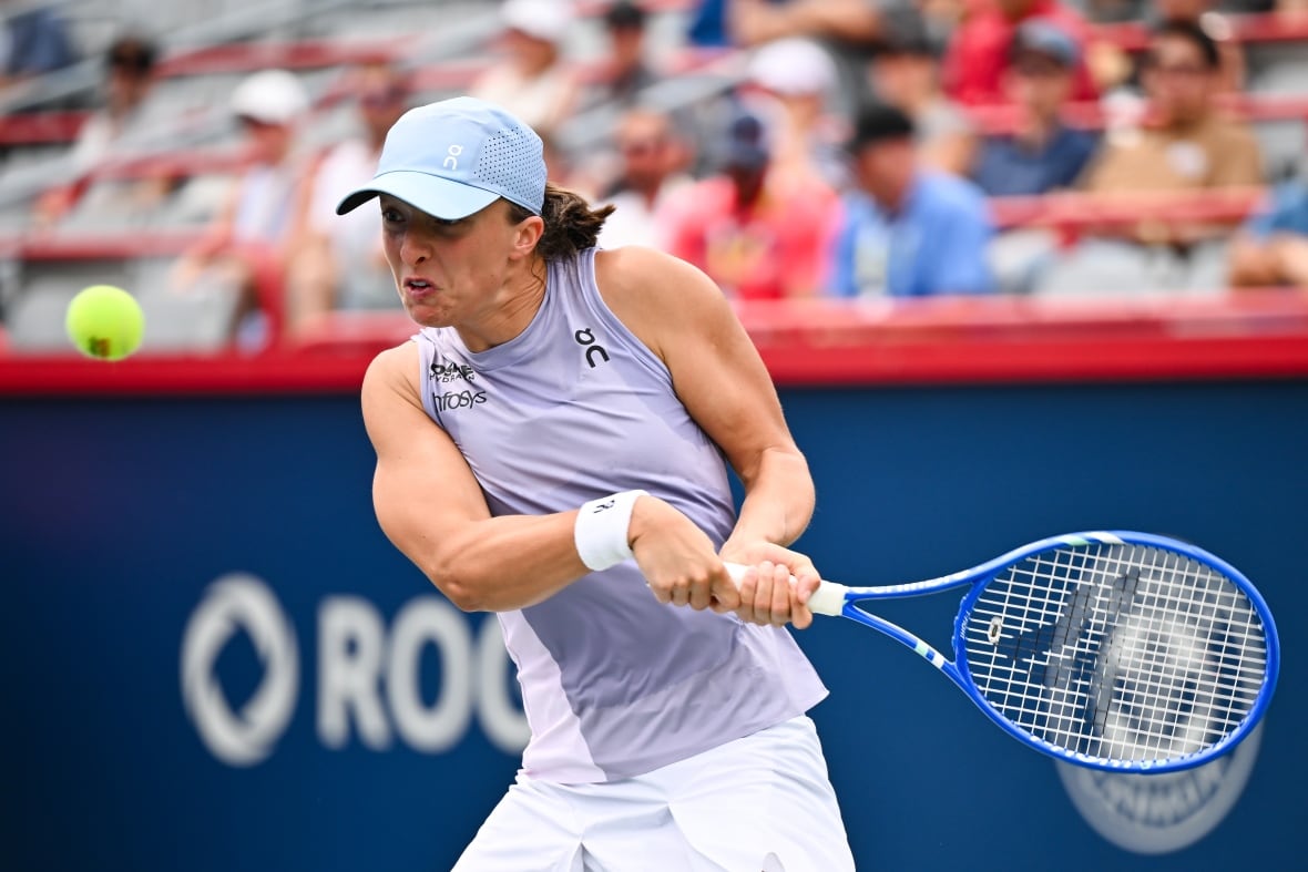 A women's tennis player plays a return shot.