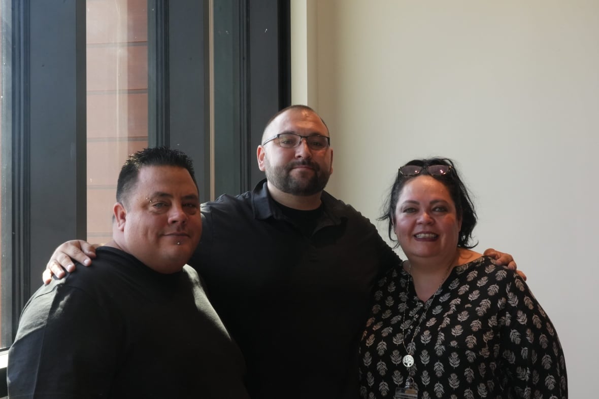 Portrait photo of two men (left and centre), and a woman (right). Middle-aged, Indigenous, dressed in casual clothes. 