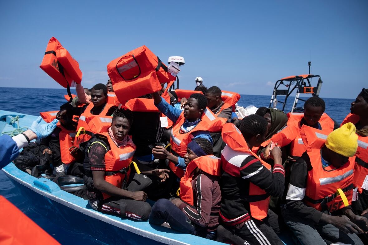 Refugees on a small rescue vessel in the Mediterranean Sea.