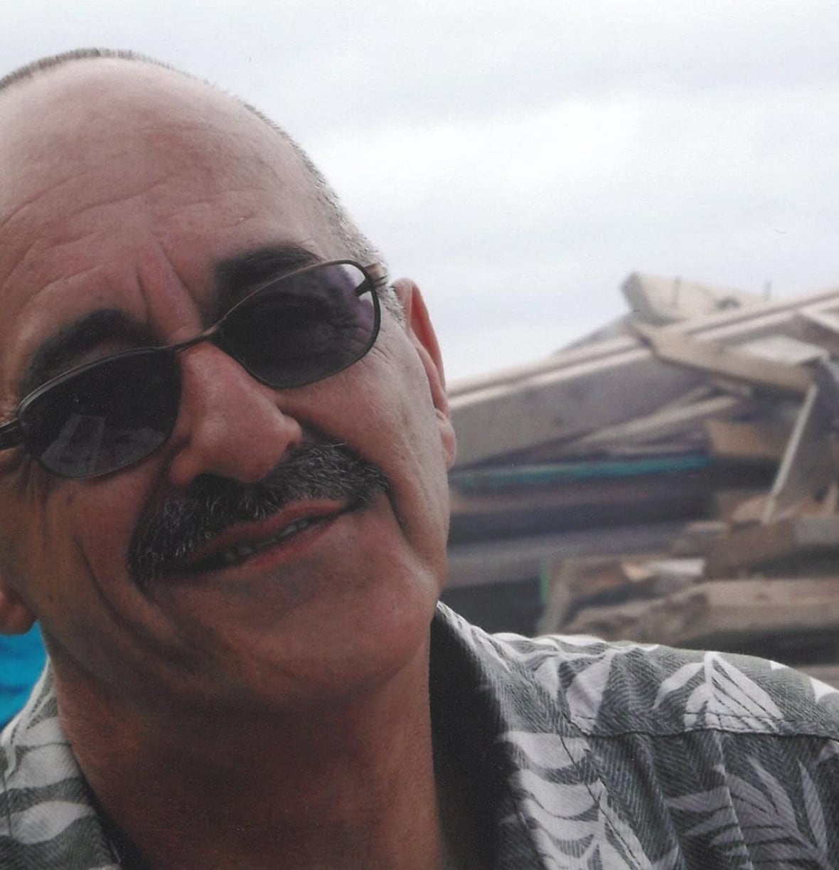 A man with glasses smiling