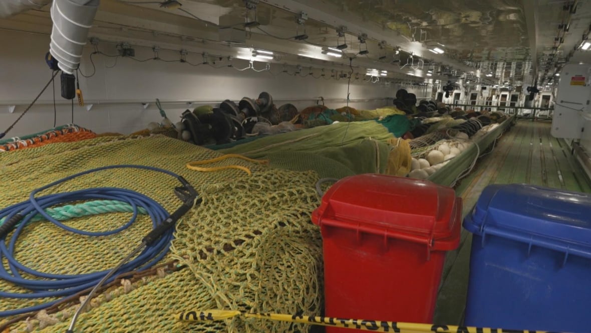 Picture of many fishing nets inside a large boat