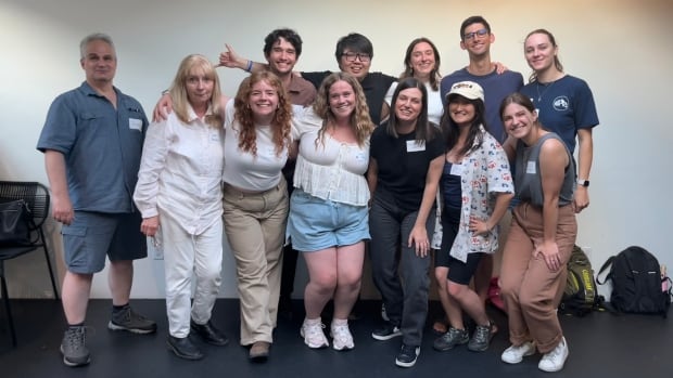 Group photos, there are 12 people standing in two rows.