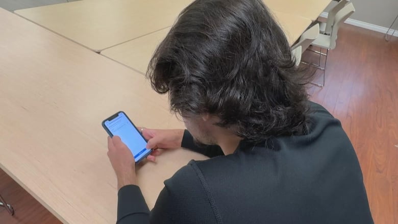 A man looks at his phone