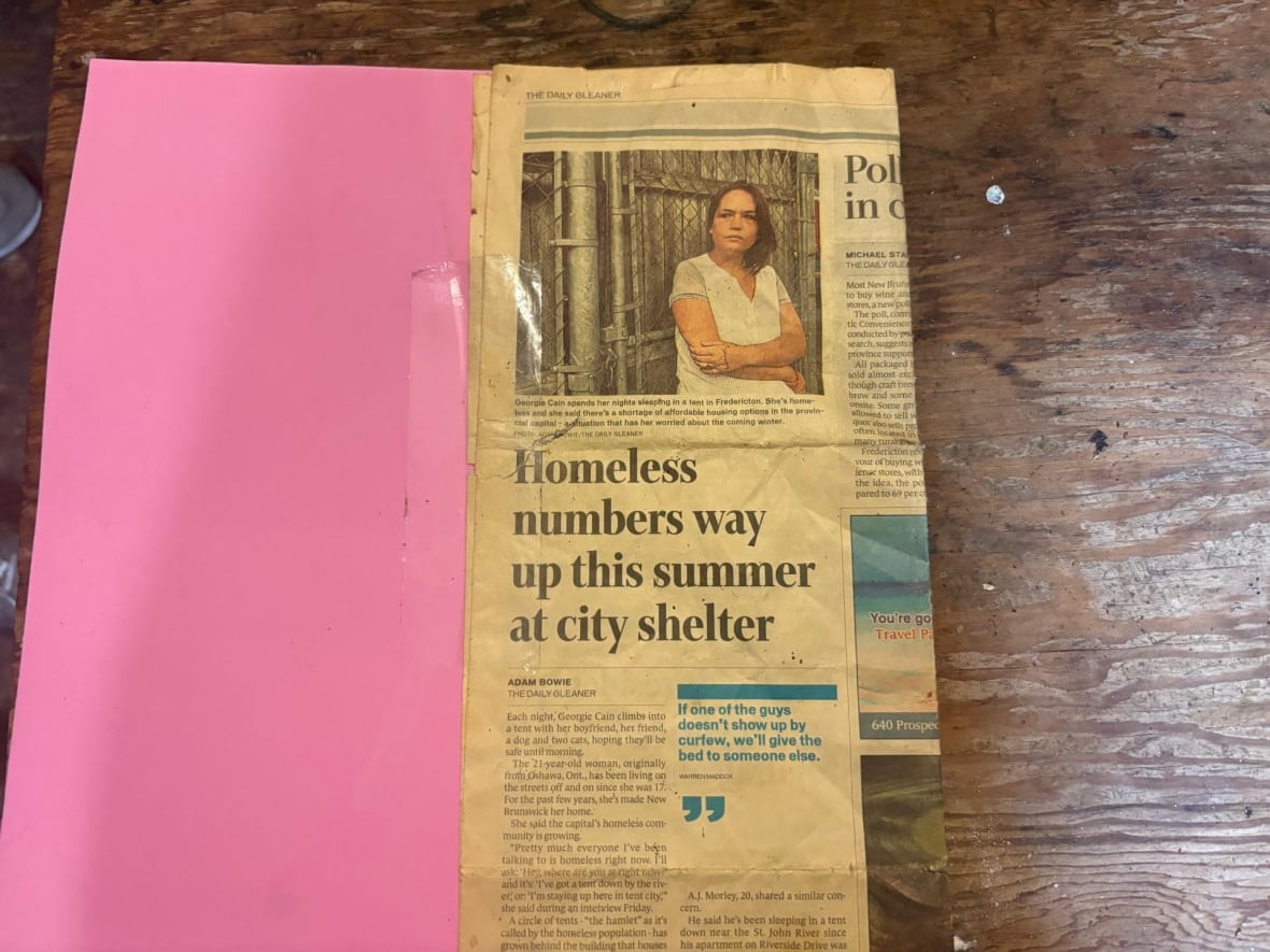 A newspaper clipping of a homeless woman