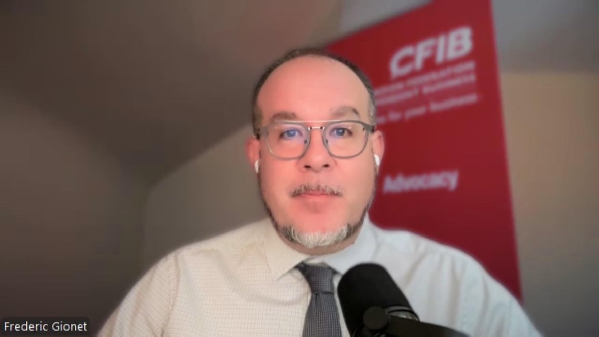 A man in a white shirt and tie on a Zoom call.