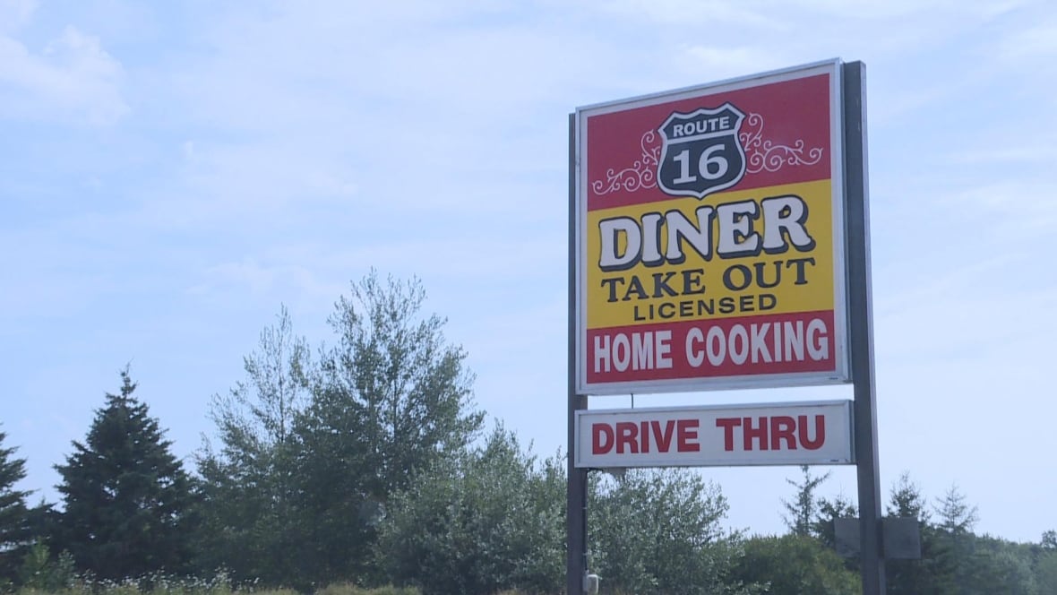 A sign for Route 16 Diner, with a blue sky in the background.