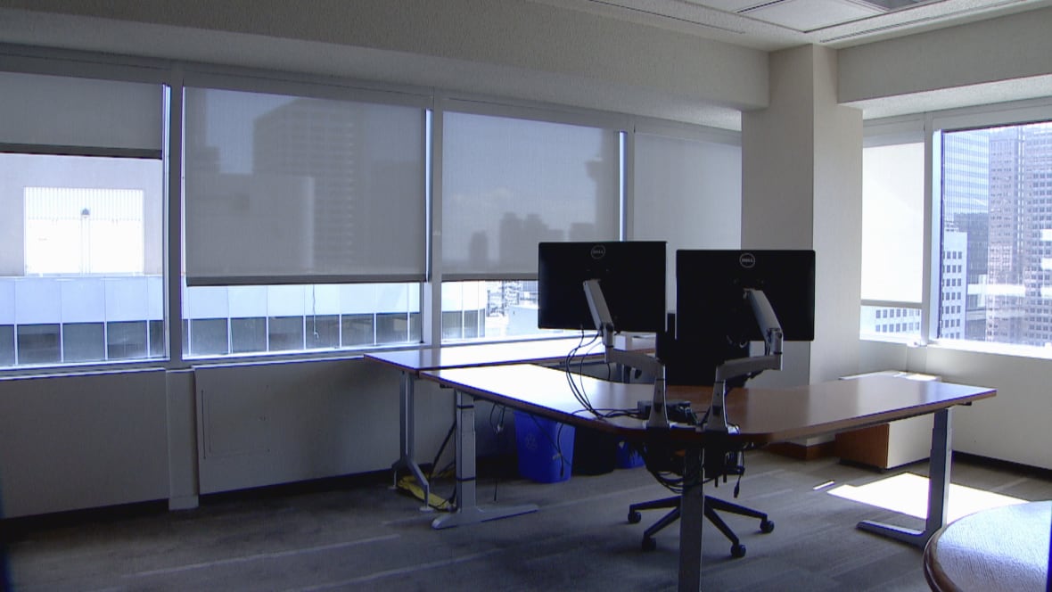 An office with a desk, computer and chair.