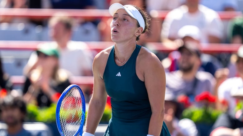 A tennis player reacts.