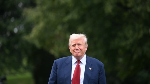U.S. President Donald Trump walking toward members of the media (unseen in image) on the South Lawn of the White House.