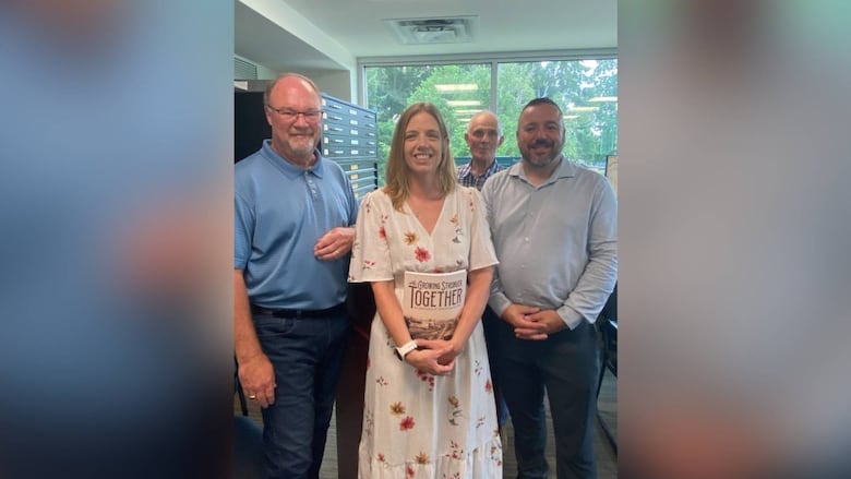 Oxford County archivist Liz Dommasch stands between the county's deputy warden and Ingersoll Mayor Brian Petrie, right, East-Zorra Tavistock Mayor Phil Schaefer, left and Norwich Mayor Jim Palmer. 